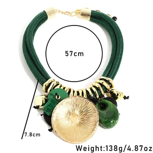 Detail view of green rope necklace with gold leaf pendant and 57cm length specs