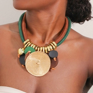 Bohemian statement necklace with green woven rope and sunburst gold leaf pendant