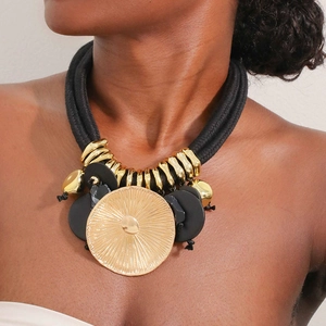 Ethnic retro necklace with bold weave rope and gold leaf lotus pendant on female model