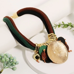 Close-up of bohemian woven rope necklace with lotus-shaped pendant and golden charms