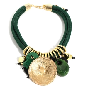 Macro detail of bohemian statement necklace with green cord and golden lotus leaf pendant