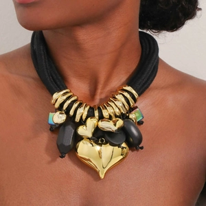 Layered chunky black rope necklace with gold heart pendants shown on a female model