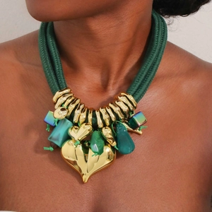 Layered chunky green cord necklace with large gold heart pendants and resin stones