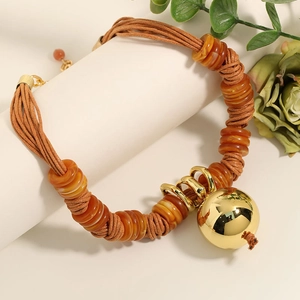 Handmade woven wax rope necklace with orange resin beads and a gold sphere pendant