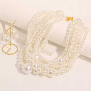 Elegant multilayer pearl necklace and earring jewelry set with golden hardware accents