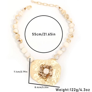 Handmade beaded stone necklace with large hammered gold pendant and white turquoise