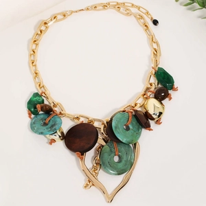 Bohemian gold chain necklace featuring green resin and large heart cutout pendant