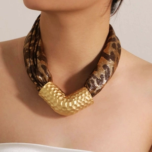 Leopard print fabric necklace with a hammered gold-tone curved metal tube pendant