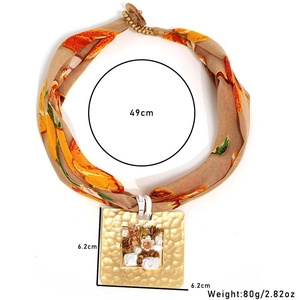 Detail view of square fabric pendant necklace with 6.2cm dimensions and 49cm chain length