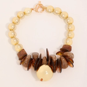 Handmade beaded necklace with yellow faux pearls, brown marble disc and gold toggle clasp