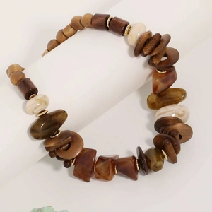 Handmade beaded necklace with wood and acrylic marble beads on a display stand