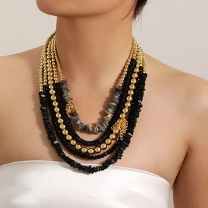 Bohemian multilayer beaded necklace with tassels and gold beads on a female model