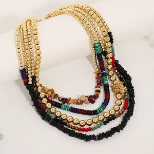 Detail of bohemian multilayer necklace with colorful beads and gold metal accents