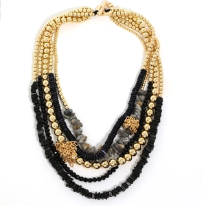 Bohemian multilayer beaded necklace with gold OT clasp and tassel details on white backdrop