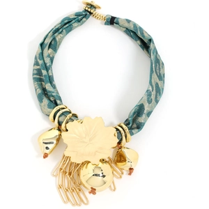 Detailed close-up of chunky gold floral pendant and teal leopard print fabric necklace