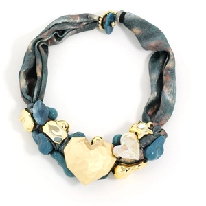 Detail of luxury ribbon necklace with large golden heart and mixed geometric charms