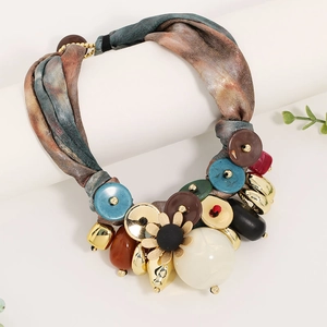 Detailed shot of bohemian ribbon necklace with flower pendant and oversized buttons