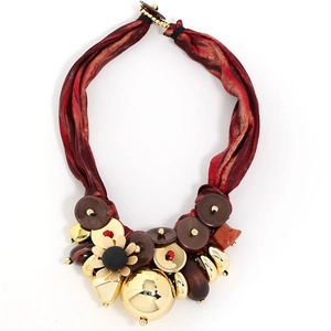 Luxurious bold ribbon necklace with gold metal flower pendant and decorative beads