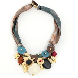 Macro detail of luxury ribbon necklace with metallic flower charms and colorful resin beads