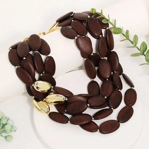 Bohemian multi-layer beaded necklace with dark brown wood and gold oval accents