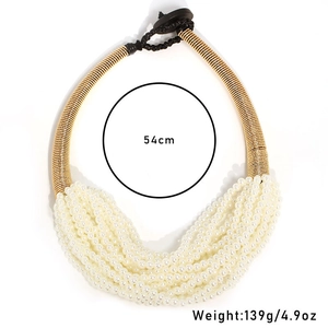 Detail view of multi-layer white pearl necklace with 54cm circumference and golden finish