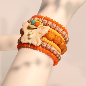 Multilayer handmade beaded bracelet featuring orange stones and a white butterfly charm