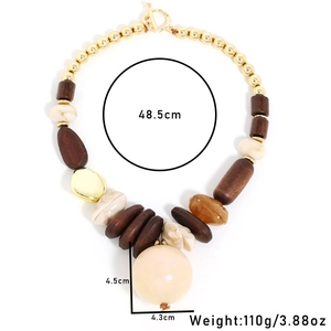 Detailed size view of retro wood and faux pearl necklace with large cream pendant