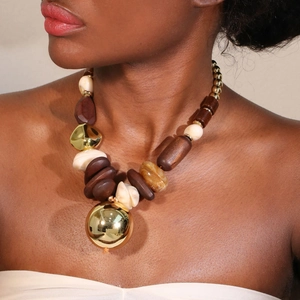 Bohemian chunky necklace featuring mixed gold metal beads and cream pearl accents