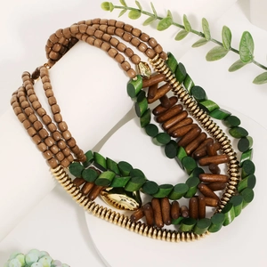 Multilayer bohemian wood bead necklace with gold shell charms on a white display pedestal