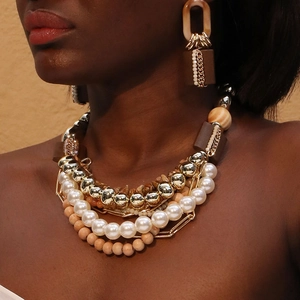 Detail of multi-layer boho necklace with pearls, wood beads and geometric resin pendants