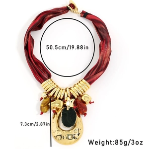 Detail view of a vintage boho necklace with red silk rope and black stone pendant