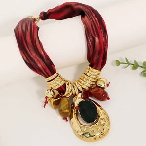 Red silk scarf necklace with gold hammered metal ring and black stone pendant detail