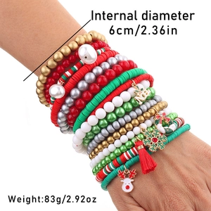 Detail of multi-layer Christmas beaded bracelets with reindeer and Noel pendants on wrist