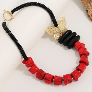 Red and black beaded necklace with a golden butterfly pendant and T-bar toggle closure