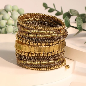 Bohemian multi-layer beaded wrap bracelet in vintage gold finish on a white display stand
