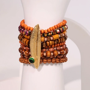 Bohemian multi-layer wooden bead bracelet set featuring a gold leaf and green gemstone charm
