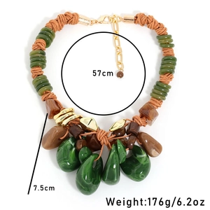 Detail of bohemian hand-woven rope necklace with malachite style resin drop pendants