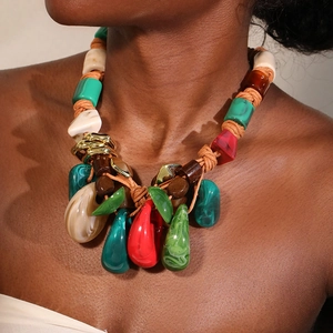 Close-up of bohemian woven rope necklace with colorful resin beads and teardrop pendant