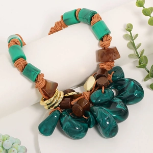 Detail of bohemian necklace with malachite resin beads and brown woven rope textures