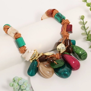 Detail of bohemian woven necklace featuring malachite-style resin pendants and geometric beads