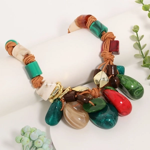 Detail of bohemian woven rope necklace with colorful resin beads and ethnic pendant