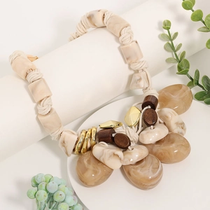 Detailed view of bohemian woven rope necklace with malachite stone pendant and resin beads
