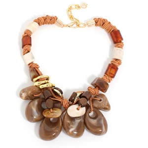 Close-up of bohemian woven rope necklace with resin beads and marble-textured pendants