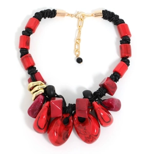 Detail of bohemian necklace with red beads and malachite-style teardrop pendant