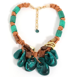 Bohemian statement necklace with green malachite beads and brown braided cord on white