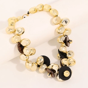 Statement chunky gold bead necklace with layered brown resin discs on black cord cord
