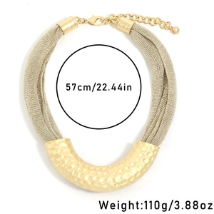 Detailed view of golden mesh chain necklace featuring a U-shaped hammered texture pendant