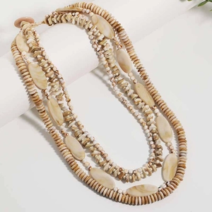Detail of bohemian layered beaded necklace with natural shell texture on display
