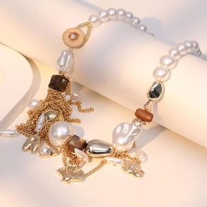 Bohemian multilayer necklace with baroque pearls, gold shell charms, and alphabet pendants