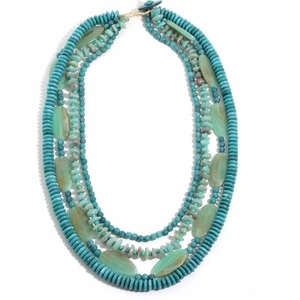 Multi-layer bohemian necklace with blue beads and green natural stones on white background